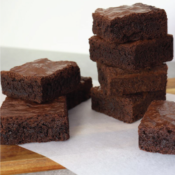 Multiple chocolate brownies on wax paper